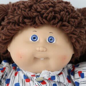 Vintage Cabbage Patch Kid girl with brown hair and blue eyes